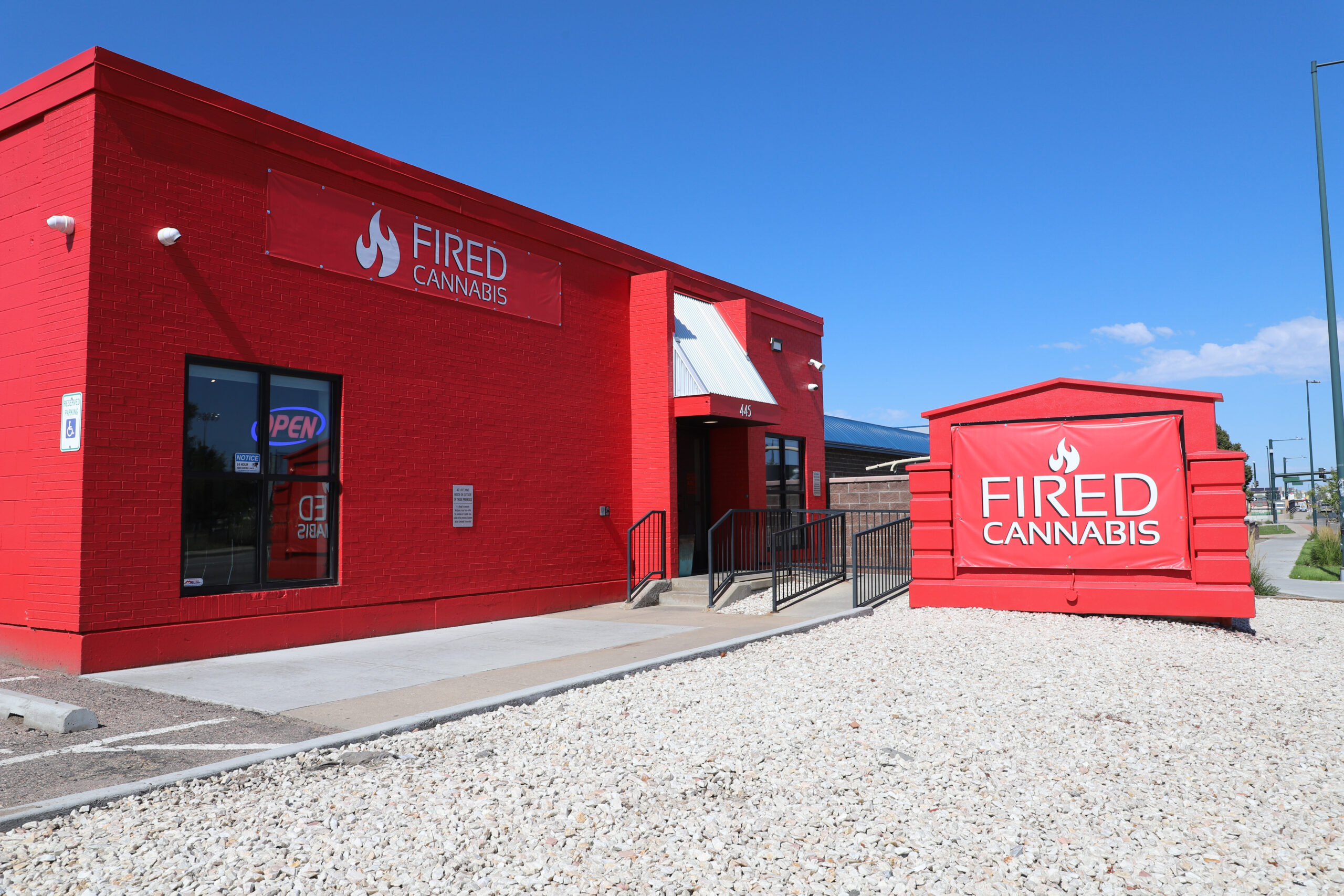 Image of Fired Cannabis store located in a red building in Denver's Barnum neighborhood.